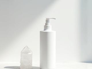 Aura Cleansing Mist spray bottle with a clear quartz crystal.